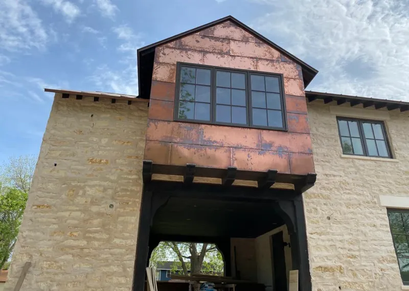 Copper metal panel facade on a stone building for Skylight Installation in Mineola